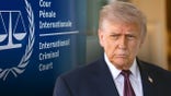Trump with a sign from the ICC in the background.