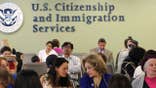 People wait inside a USCIS office as the agency changes its asylum adjudication process