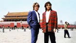 George Michael and Andrew Ridgeley pose in Tiananmen Square with Tiananmen Gate visible behind them.