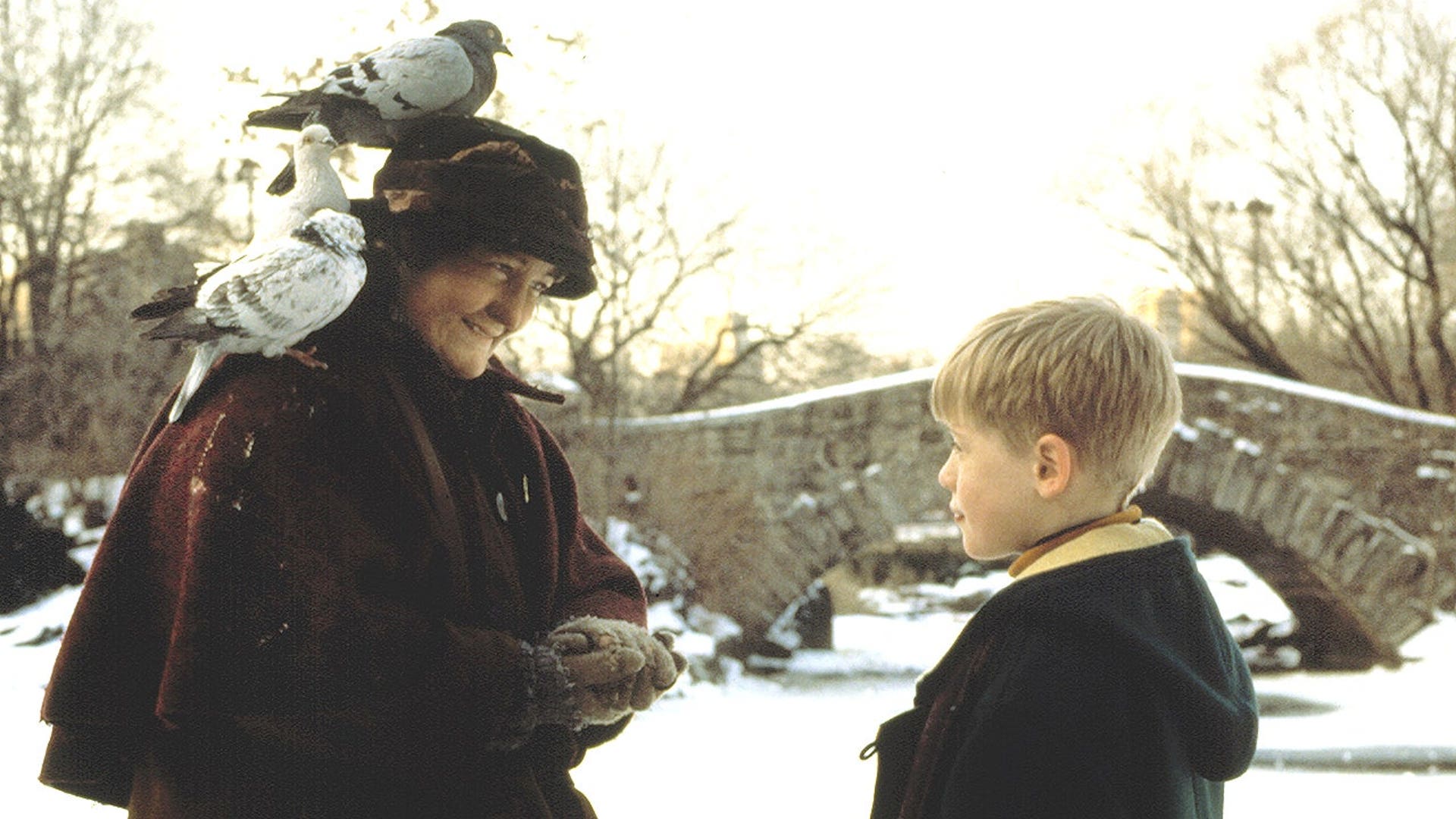 Macaulay Culkin stands with Brenda Fricker in a scene from Home Alone 2: Lost in New York.