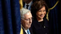 Elaine Chao stayed in China on a planned trip while Mitch McConnell entered his third week of hospitalization, as online rumors swirl about his condition.