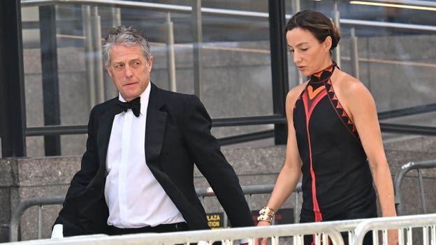 Hugh Grant and his wife, Anna Eberstein, arrive at Taylor Swift's reported wedding