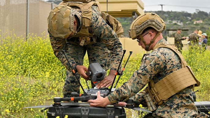 Camp Pendleton, CA - June 06: Corporals Nathan Baptiste, left, and Jacob Bennett attach a camera to an observation UAV during tactical scenario training of offensive and defensive drone capabilities at Camp Pendleton on Friday, June 6, 2025. (Photo by Jeff Gritchen/MediaNews Group/Orange County Register via Getty Images)