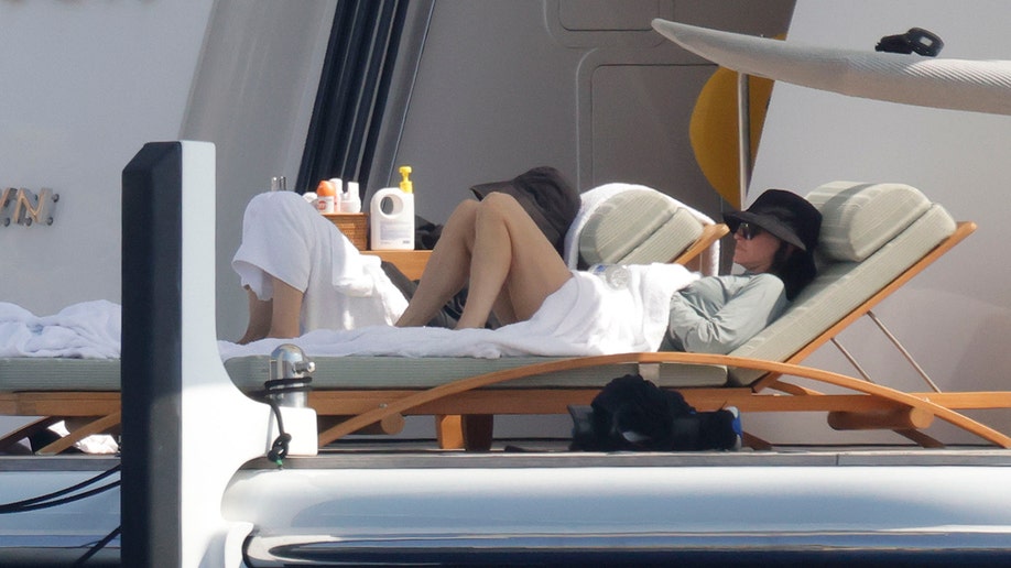 Courteney Cox laying on a lounge chair while on vacation in Mallorca.