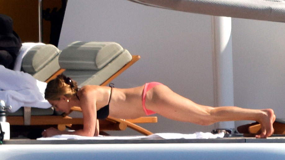 Jennifer Aniston doing a plank on the yacht while on vacation.