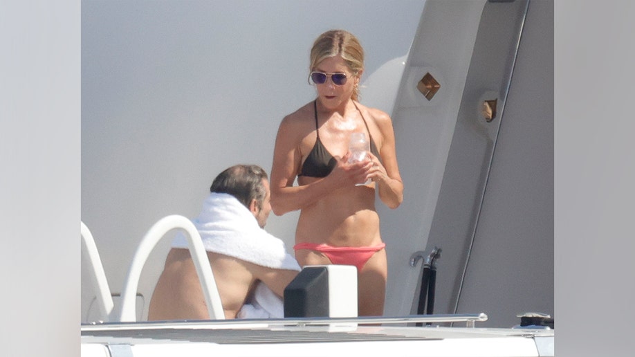 Jennifer Aniston and her boyfriend Jim Curtis talking while on vacation in Mallorca in July 2026.