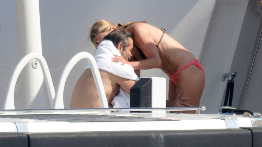 Jennifer Aniston and Jim Curtis embracing while on vacation in Mallorca.