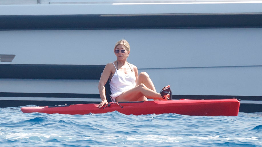 Jennifer Aniston using a pedal boat while on vacation.