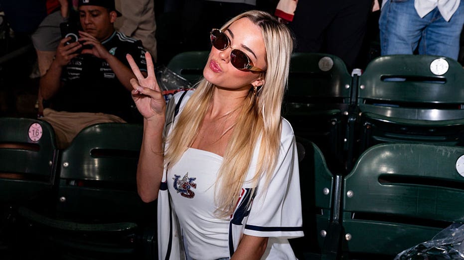 Livvy Dunne serves up foamy beers at the Home Run Derby & Hannah Barron goes bikini bowfishing