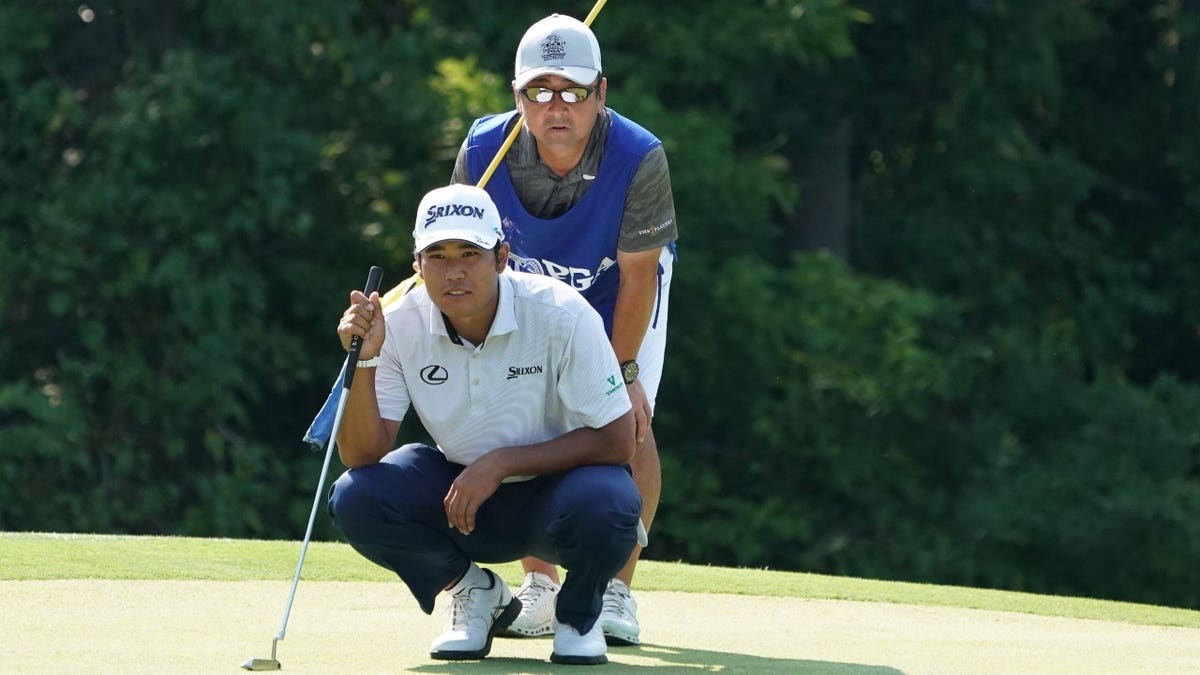 Hideki Matsuyama lines up a putt during the third round of the 20218 PGA Championship at Bellerive Country Club in St. Louis, Missouri.