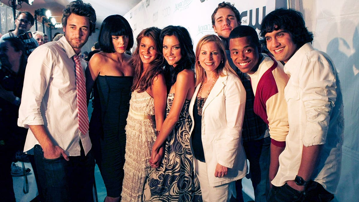 Ryan Eggold, AnnaLynne McCord, Shenae Grimes, Jessica Stroup, and other cast members pose at a premiere party.