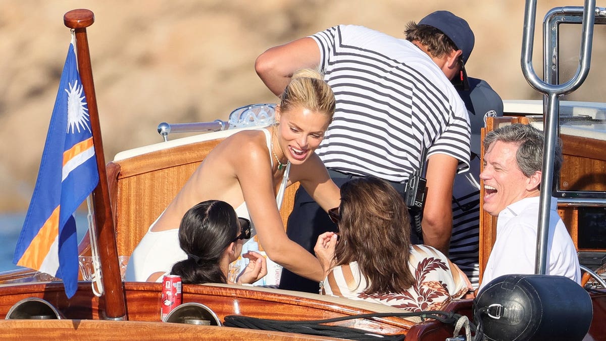 Brooks Nader laughs with her family on a boat in Italy