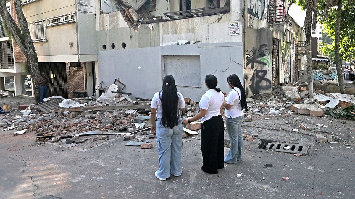 Colombian women looking at earthquake destruction