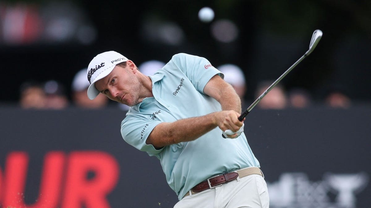 Russell Henley hits a tee shot on the 11th hole during the 2025 TOUR Championship at East Lake Golf Club in Atlanta, Georgia.