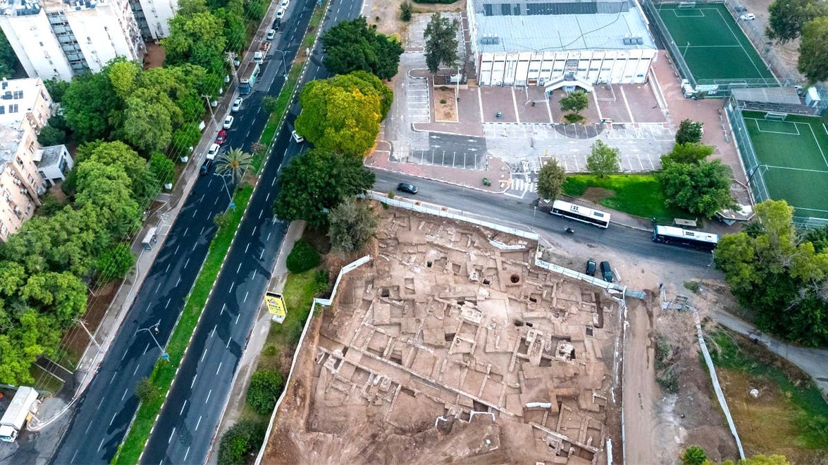 Aerial view of excavation site next to major highway