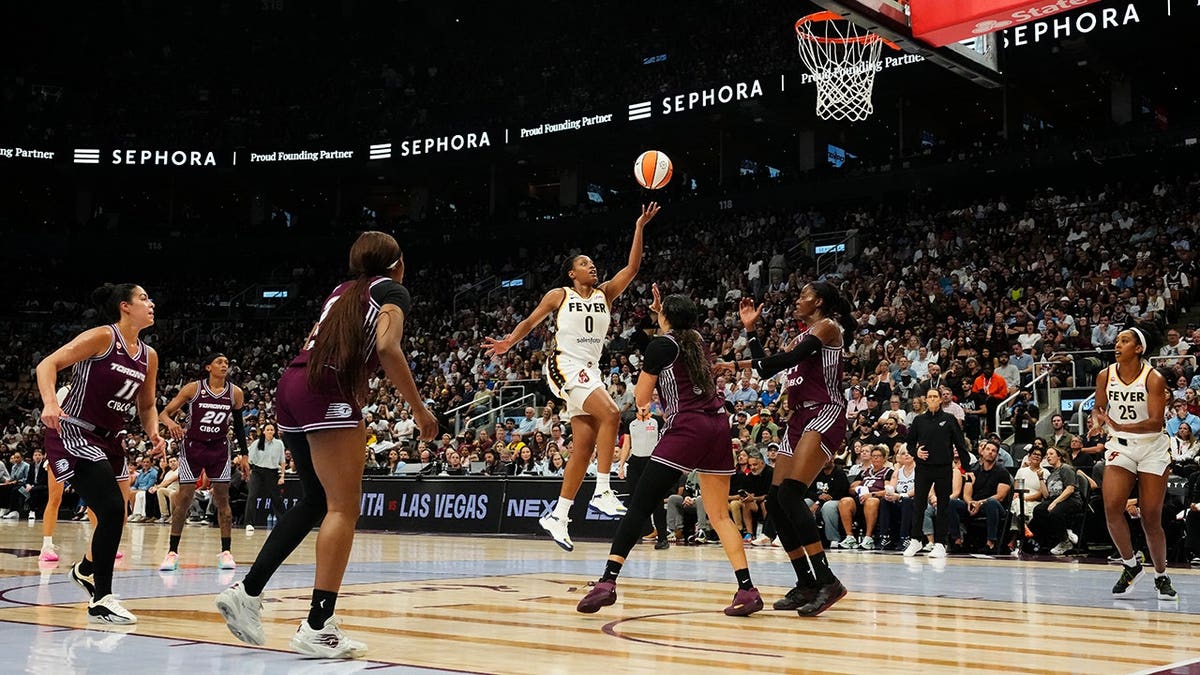 Kelsey Mitchell scores during a WNBA game.