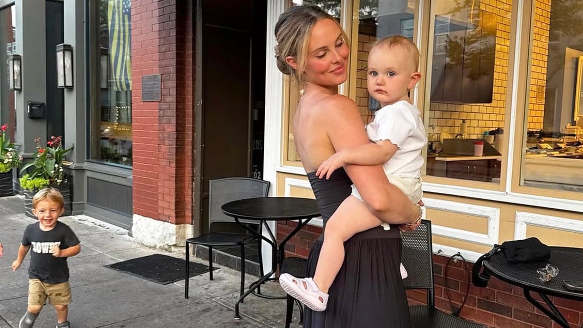 Jade Kircus walking with her children outside.