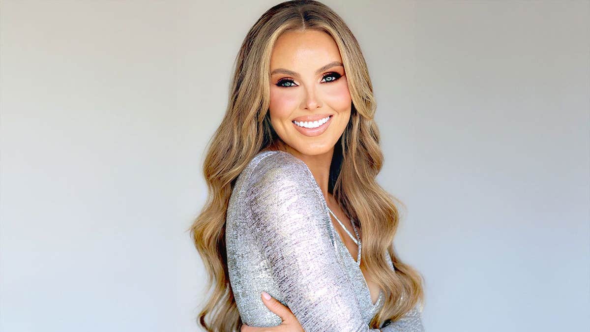 Jade Kircus wearing a sparkling silver dress and smiling.