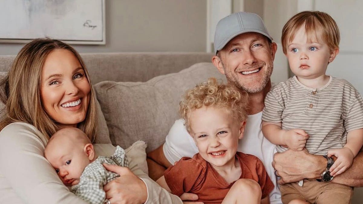 Jade Kircus and her family smiling in a cozy family portrait.