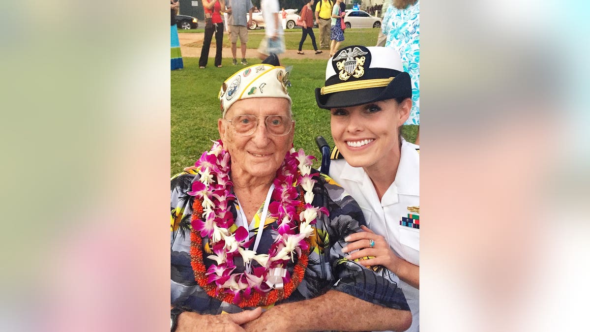 Jade Kircus in her Navy uniform posing with a veteran.