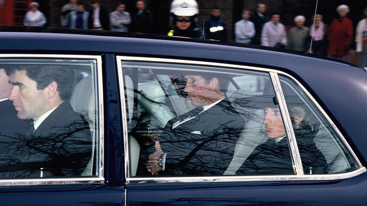 Prince Charles and Princess Diana arrive by car in London, England.