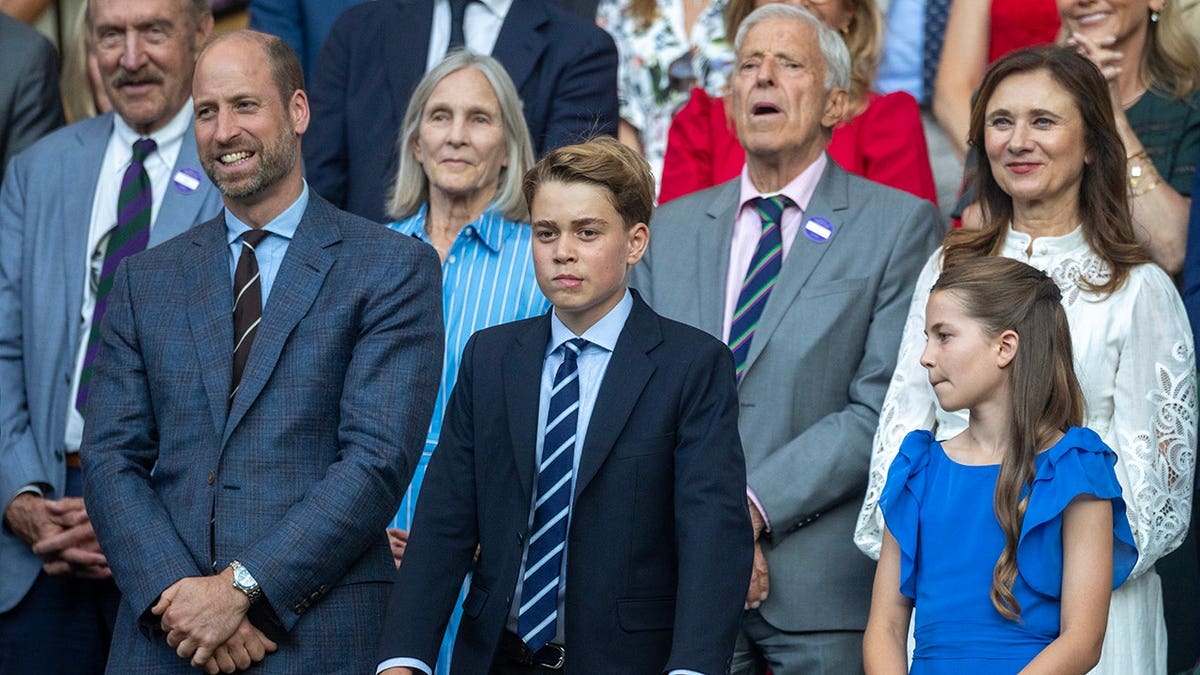 Prince William, Prince George and Princess Charlotte sit in the Royal Box at Wimbledon.