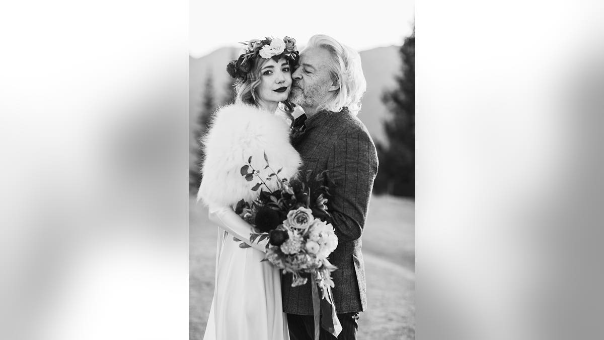 Roland Orzabal and Emily Rath posing for their wedding portrait.