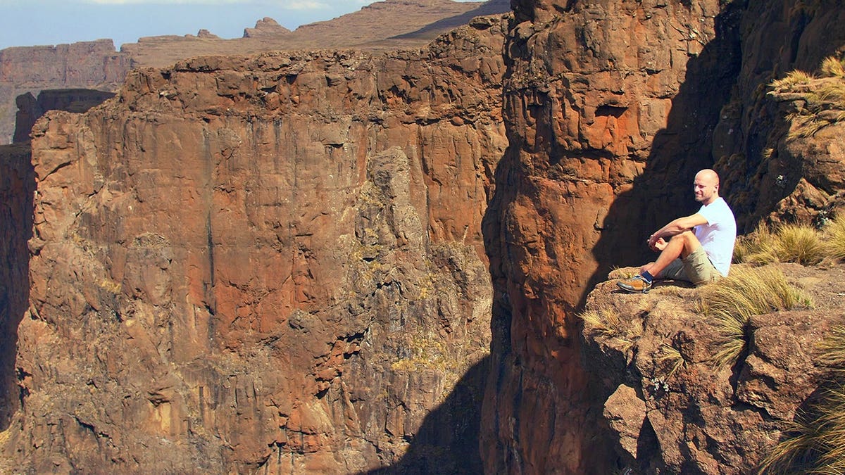 View of hiker sitting on Mozambique cliff