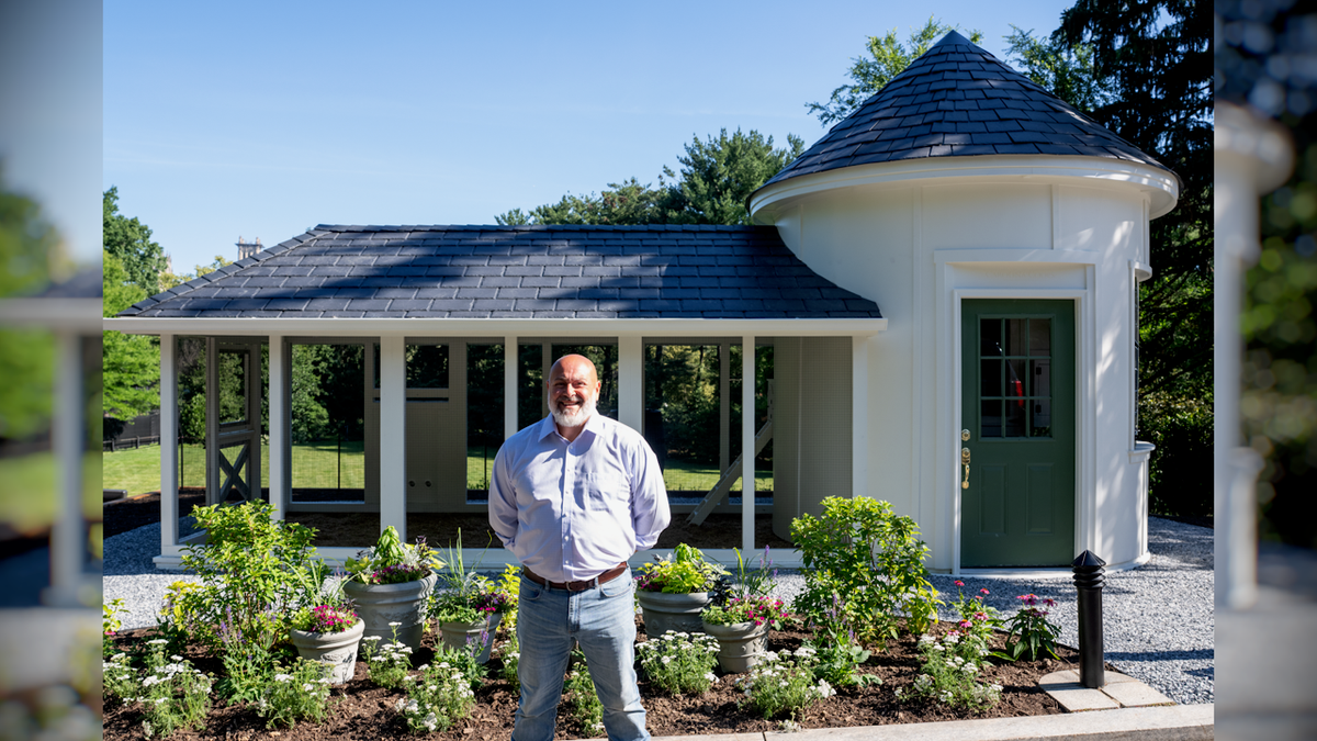 Matt Duboise stands in front of the chicken coop he made for the Second Family.