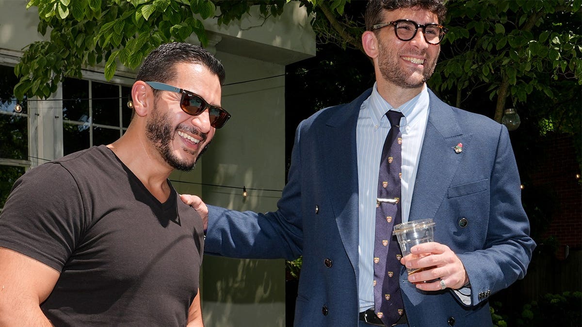 Abdul El-Sayed and Hasan Piker talk poolside at a Detroit party.