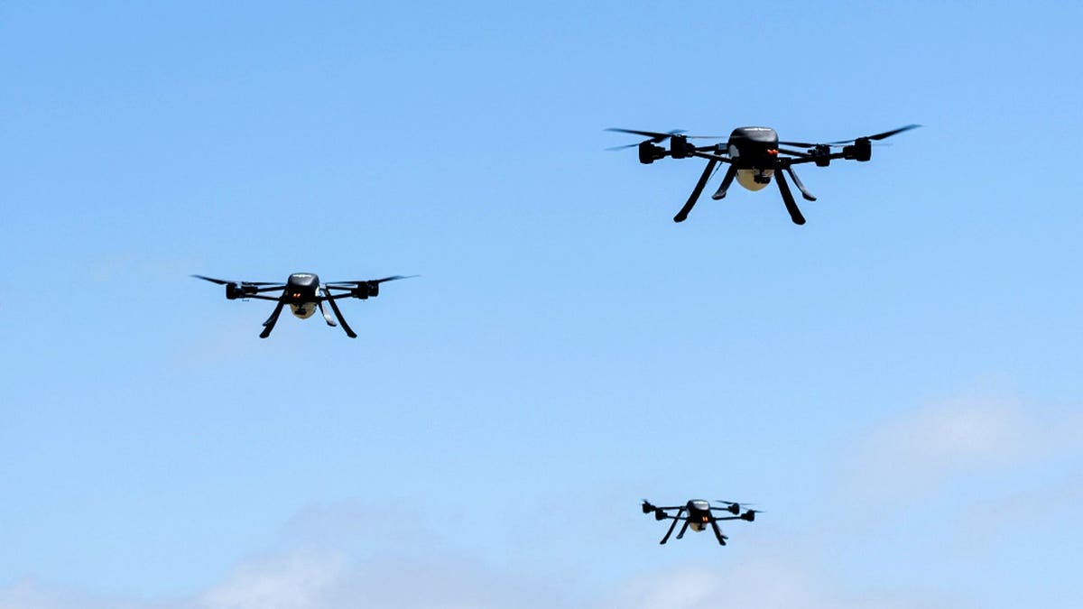 Firefighting drones fly in the sky.