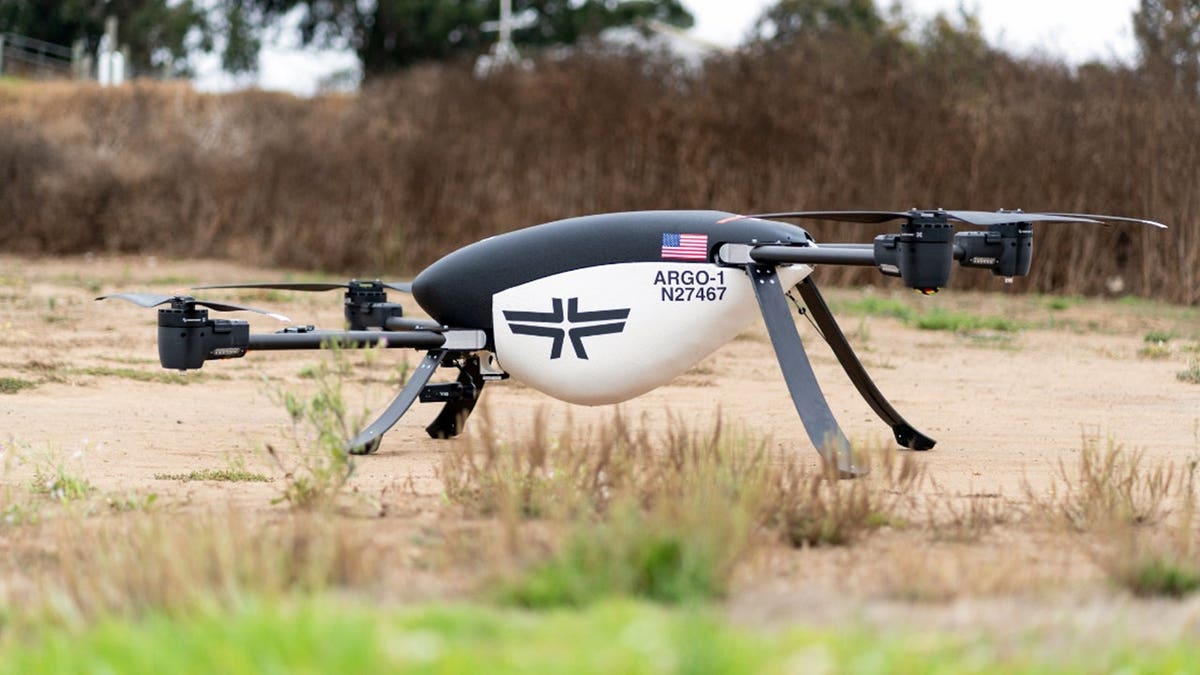 A firefighting drone sits in a field.