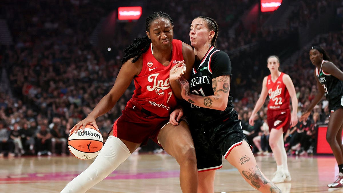 Aliyah Boston drives to the basket as Emily Engstler defends.