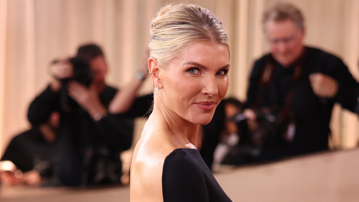 Amanda Kloots poses on the red carpet at the Golden Globes.