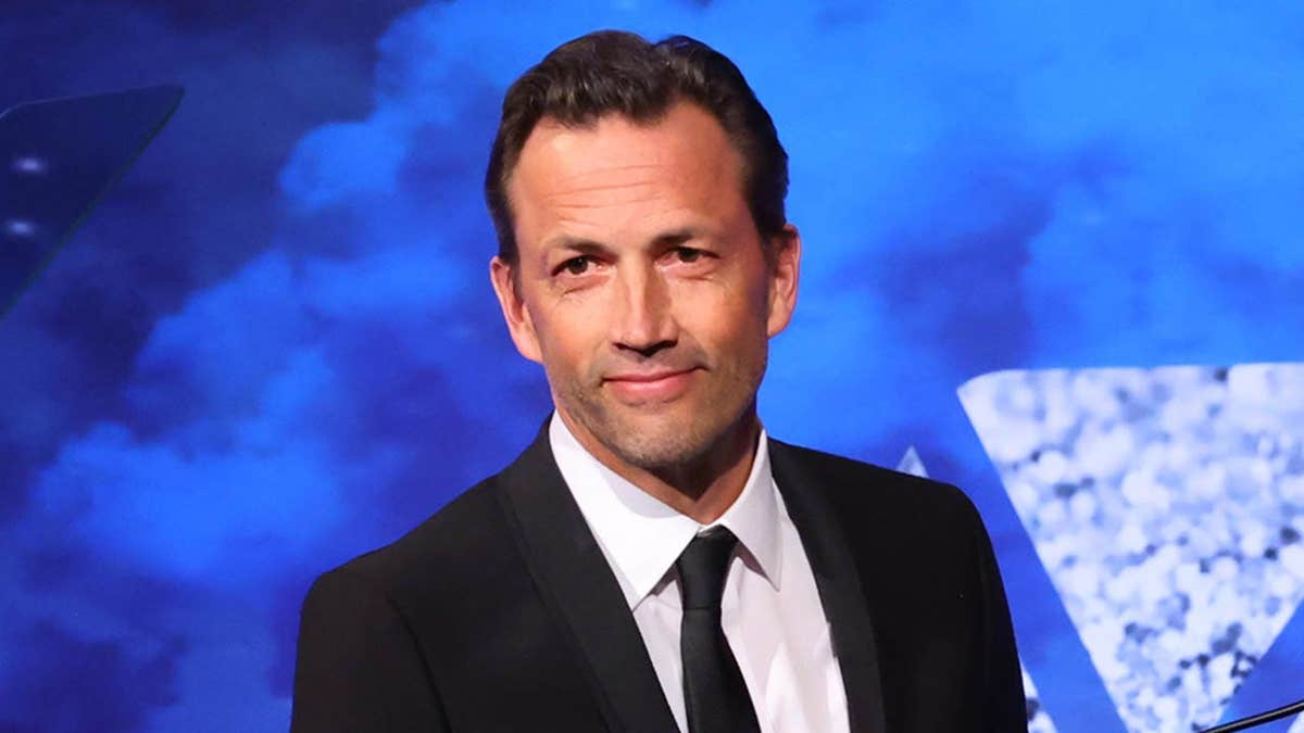 Andrew Shue and Amy Robach speak onstage at the ADAPT Leadership Awards.