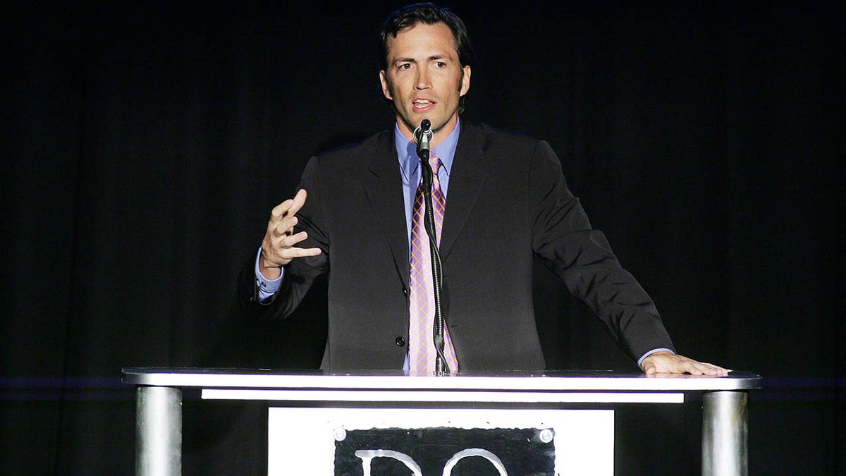 Andrew Shue speaking at a podium in 2005
