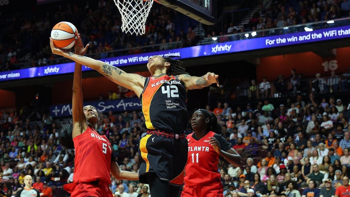 Angel Reese #5 blocks Brittney Griner's shot during a WNBA game.