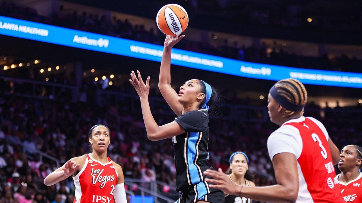 Angel Reese shoots against the Las Vegas Aces at State Farm Arena.