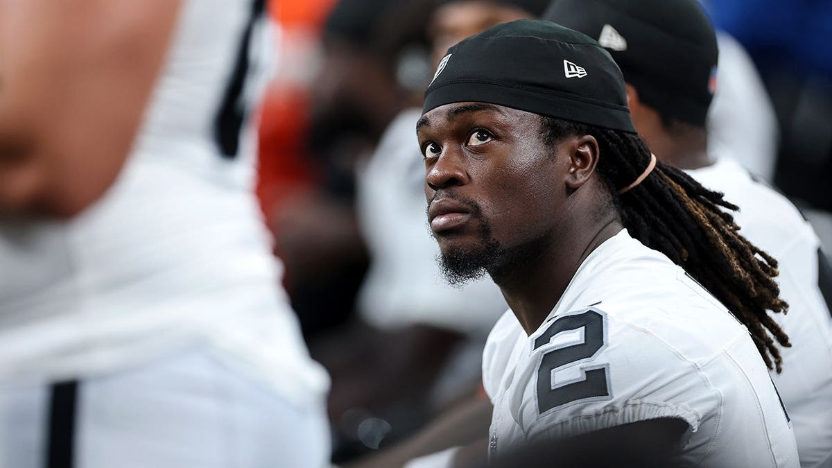 Ashton Jeanty sits on the bench during a preseason game between the Las Vegas Raiders and Houston Texans.