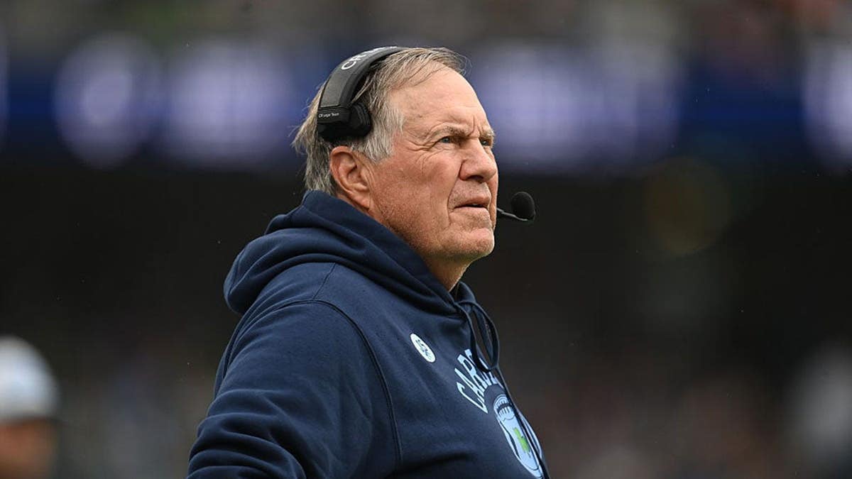 Bill Belichick watches from the sidelines during a football game in Dublin.