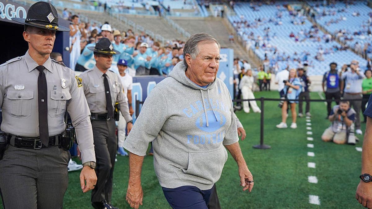 Bill Belichick walks onto the field at Kenan Stadium.
