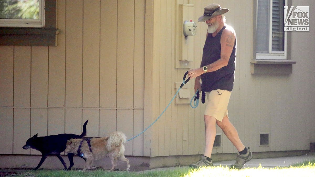 Brian Hooker walks a dog in California.