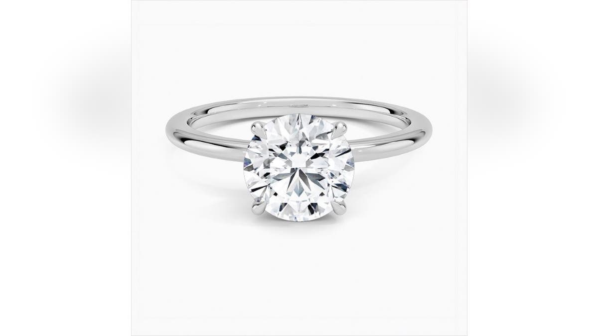 A petite round diamond gives this solitaire a classic look.