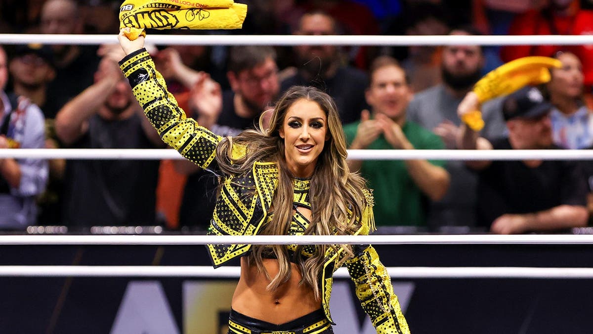 Dr. Britt Baker waves a Terrible Towel in the ring.