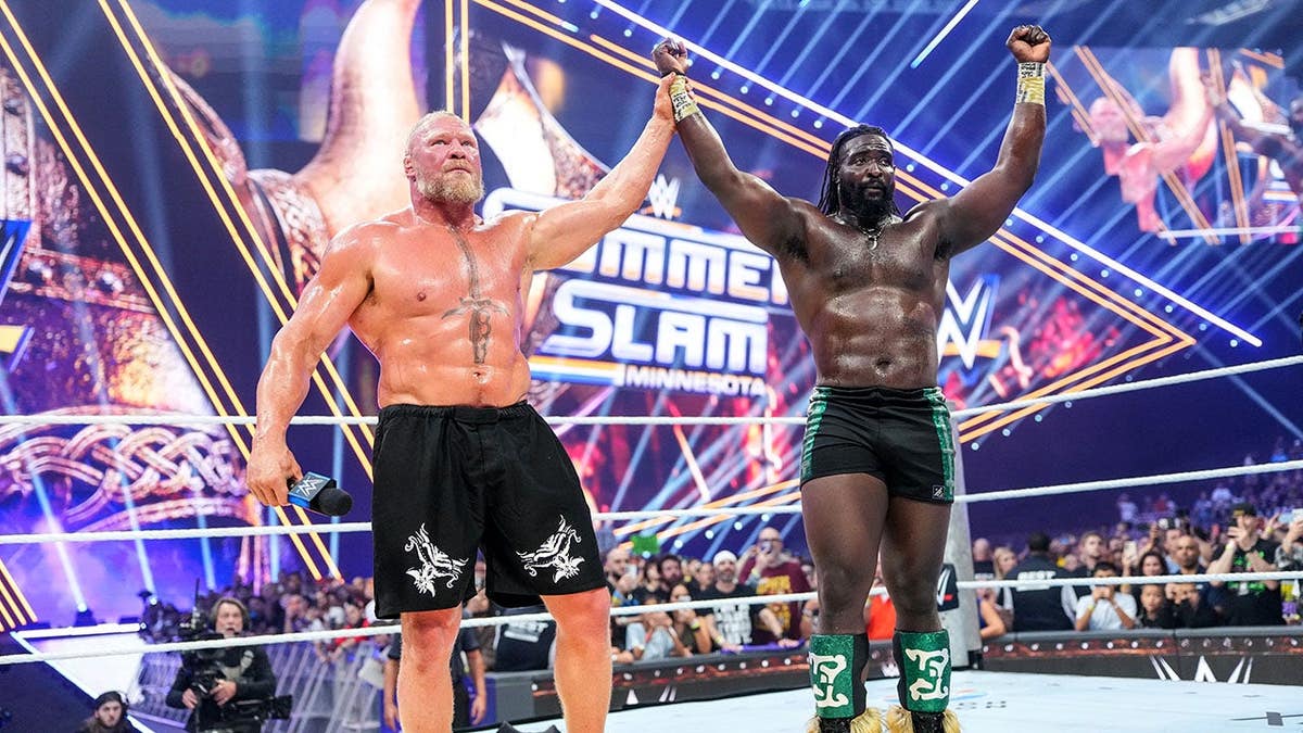 Brock Lesnar raises Oba Femi's hand at U.S. Bank Stadium.