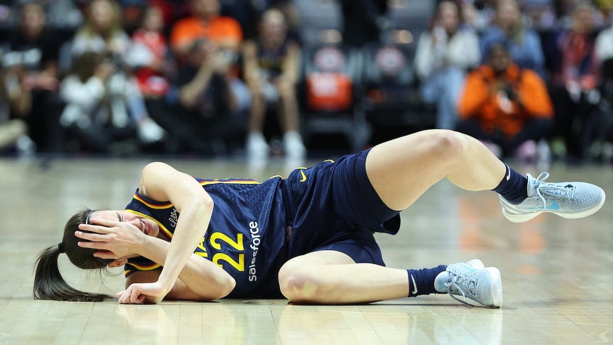 Caitlin Clark reacts after getting hit in the eye during a WNBA playoff game.