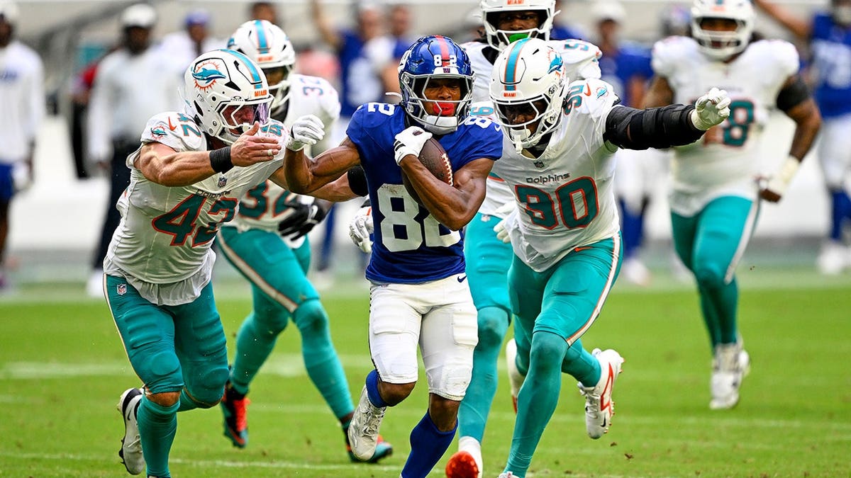Calvin Austin III runs with the ball during a preseason NFL game.