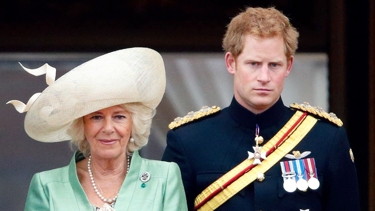Camilla, Duchess of Cornwall, and Prince Harry stand on Buckingham Palace balcony during Trooping the Colour.