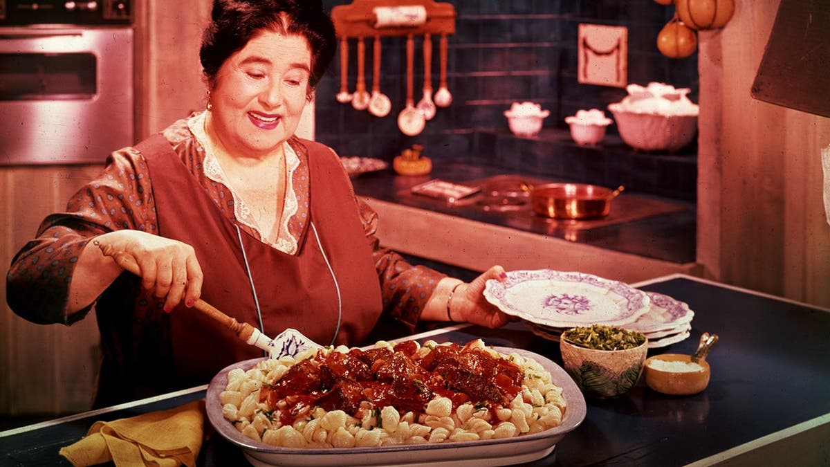 A woman prepares a noodle casserole in 1955.