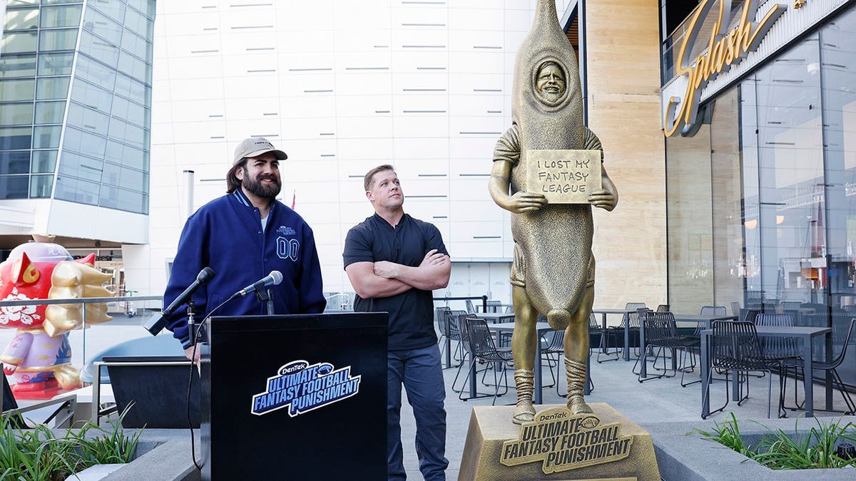 CJ Kempler and Jon Weeks speak during a fantasy football event at a sports bar.